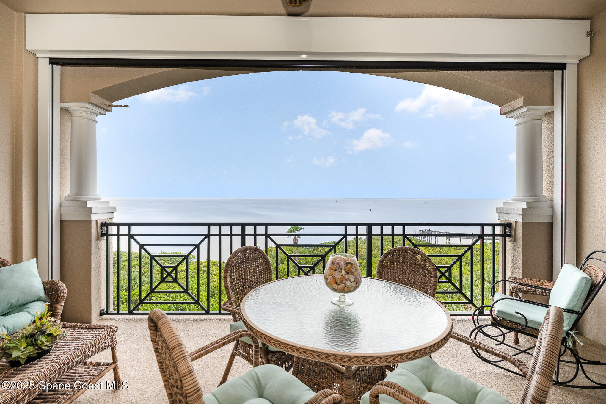 2022 Julep Drive, Unit 304 Cocoa Beach, FL 32931 - Photo 5 of 34 a balcony with table and chairs
