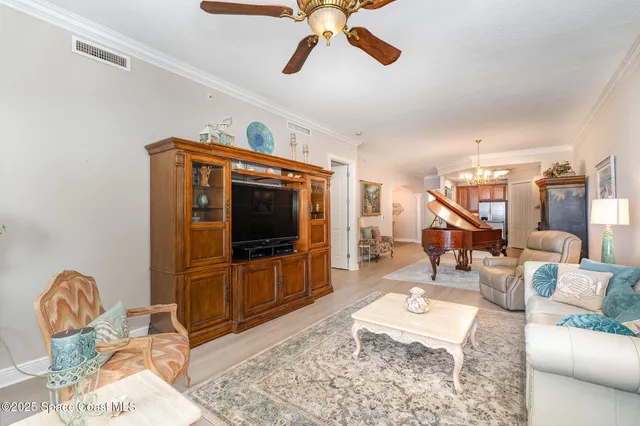 a living room with furniture a rug and a flat screen tv