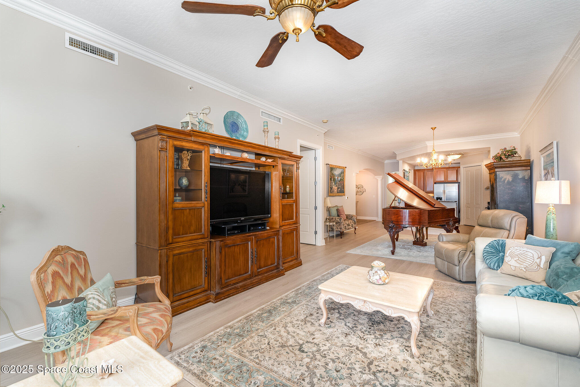 2022 Julep Drive, Unit 304 Cocoa Beach, FL 32931 - Photo 7 of 34 a living room with furniture a rug and a flat screen tv