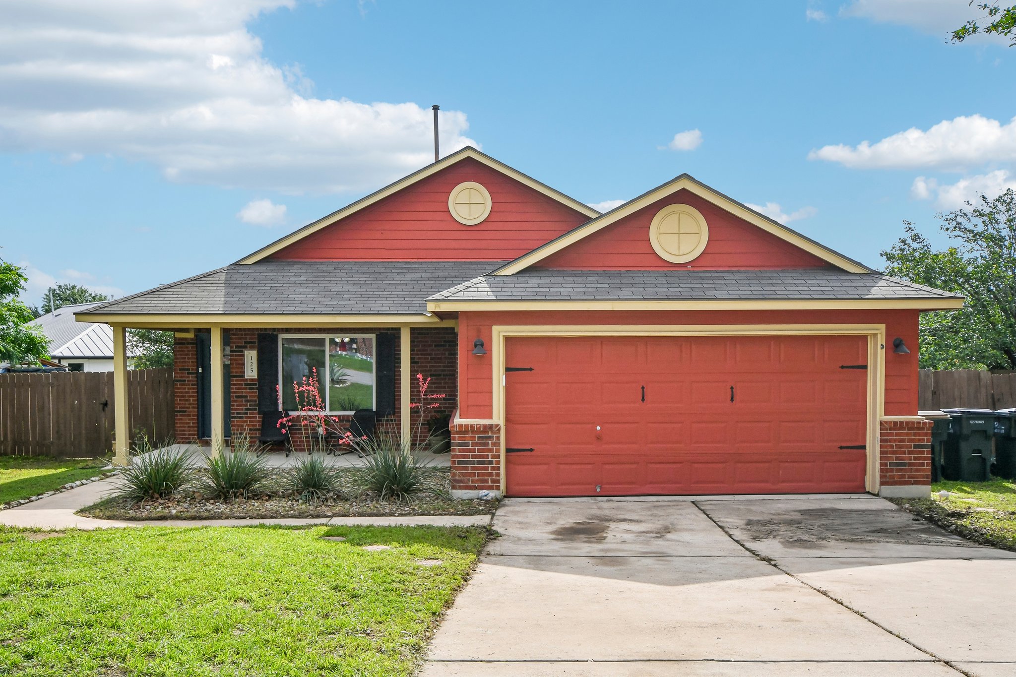 125 Mason Reed Cove Kyle, TX 78640 - Photo 1 of 39 a front view of a house with garden