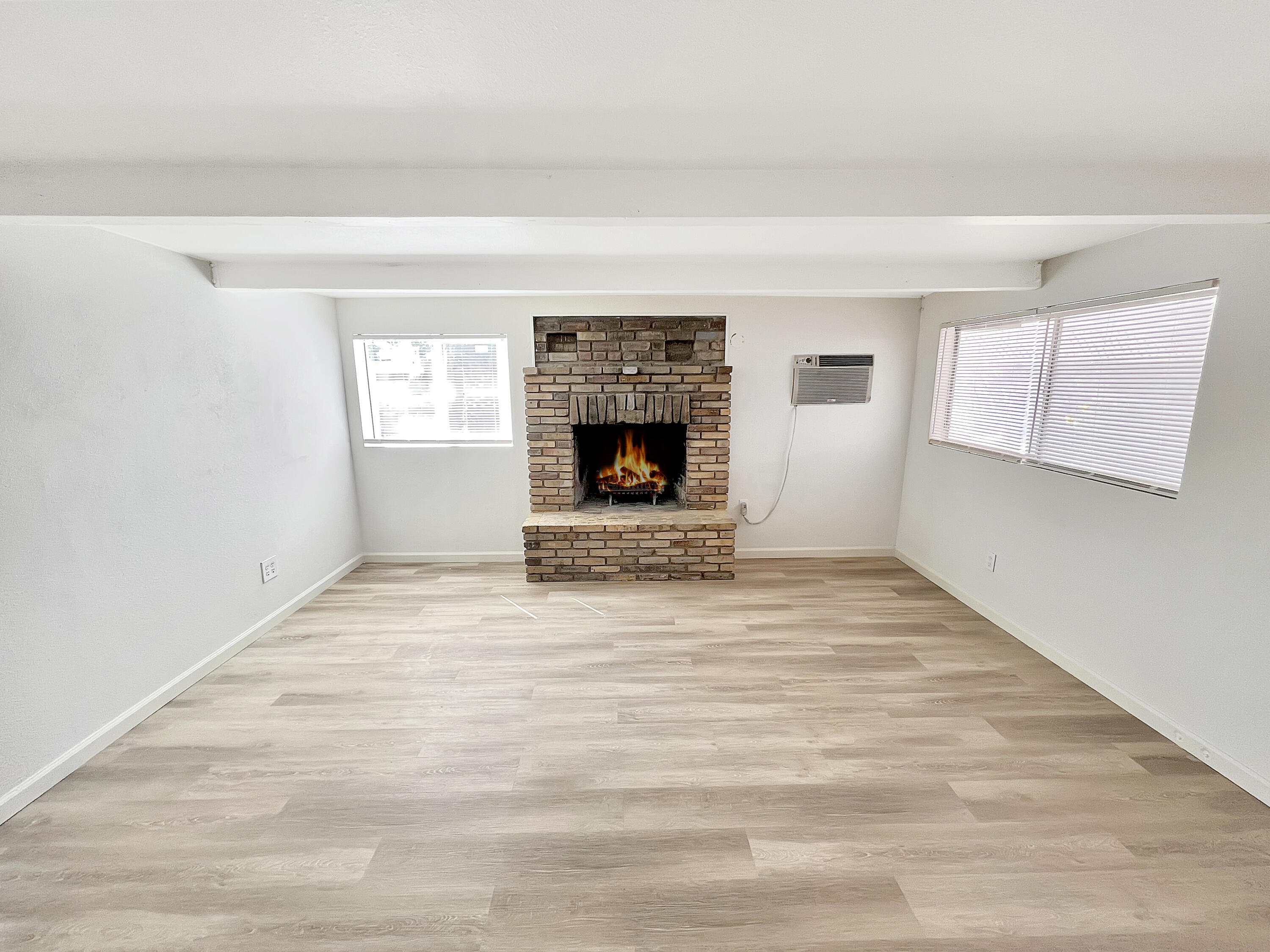 1226 Ave H 15 Lancaster, CA 93534 - Photo 15 of 15 a view of an empty room with a window and fireplace