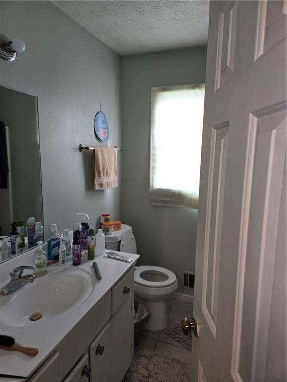 3542 North Hopkins Court Powder Springs, GA 30127 - Photo 15 of 22 a bathroom with a sink mirror toilet and next to a window