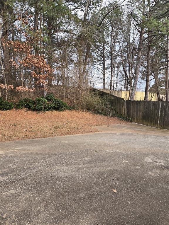 3542 North Hopkins Court Powder Springs, GA 30127 - Photo 20 of 22 a wooden bench sitting in middle of a yard