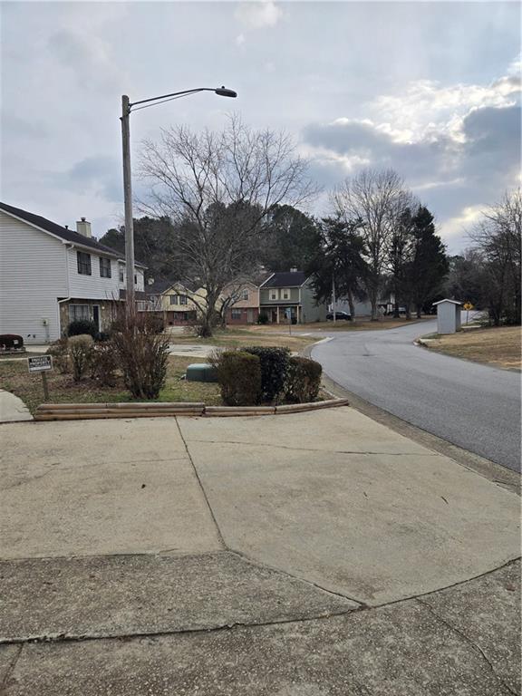 3542 North Hopkins Court Powder Springs, GA 30127 - Photo 2 of 22 a swimming pool with outdoor seating and trees