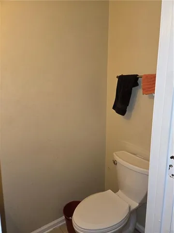 a white toilet sitting next to a shower