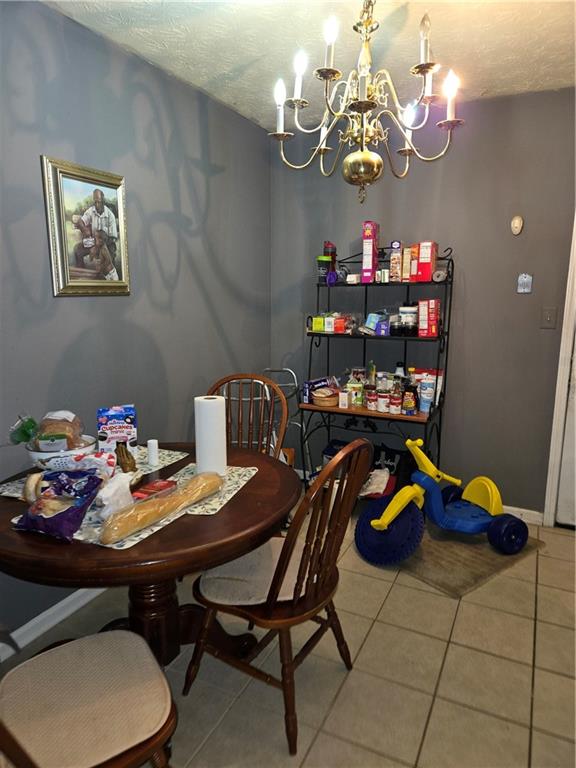 3542 North Hopkins Court Powder Springs, GA 30127 - Photo 10 of 22 a view of a dining room with furniture and chandelier