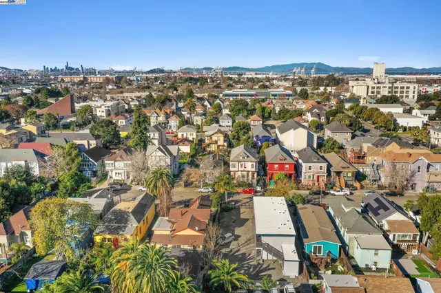 an aerial view of residential houses with city view