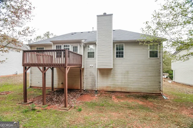 a view of a house with backyard and balcony