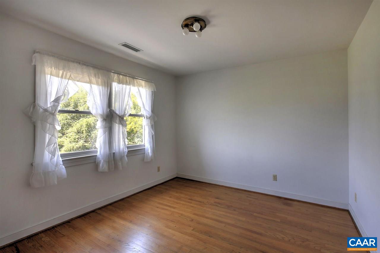 1715 Merriefields Lane Ruckersville, VA 22968 - Photo 25 of 34 an empty room with wooden floor and windows