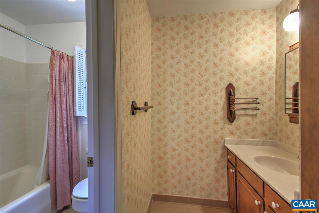 1715 Merriefields Lane Ruckersville, VA 22968 - Photo 26 of 34 a bathroom with a granite countertop sink a toilet and shower