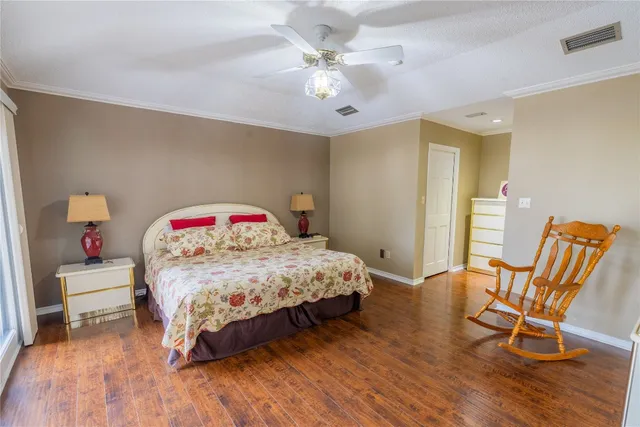 a bedroom with a large bed a chandelier and a window