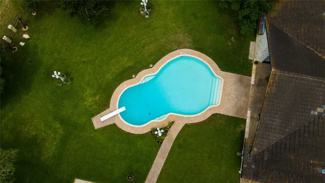 an aerial view of a houses with outdoor space swimming pool and outdoor seating
