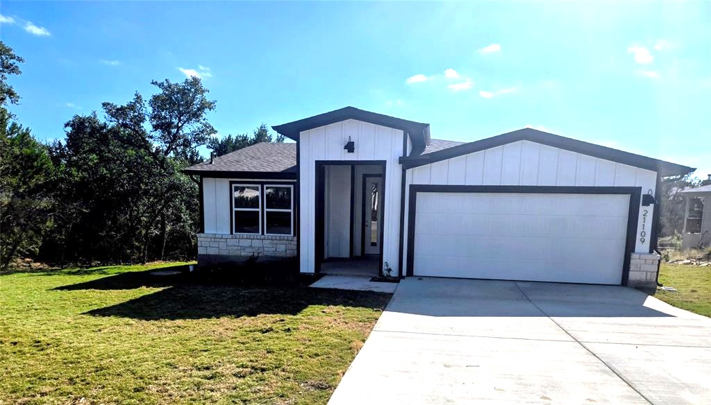 a front view of a house with a yard and garage