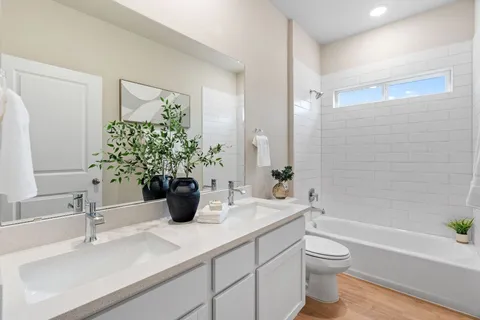a bathroom with a sink a toilet and a bathtub