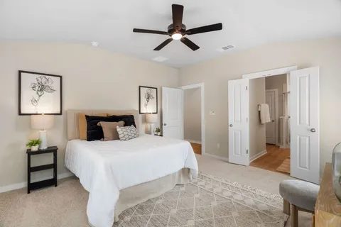 a bedroom with a bed and a chair