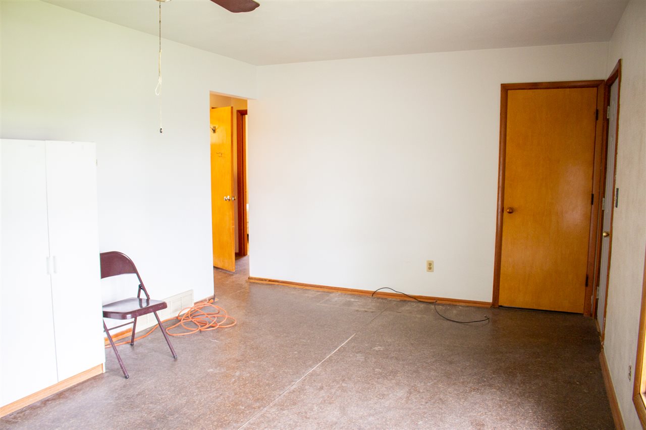 8344 Elevator Road Roscoe, IL 61073 - Photo 3 of 13 a view of an empty room with window and a chair