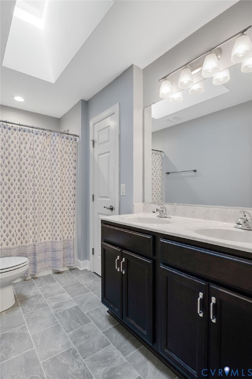 4990 Scandia Road Sandston, VA 23150 - Photo 12 of 25 a bathroom with a sink a toilet a large mirror and shower