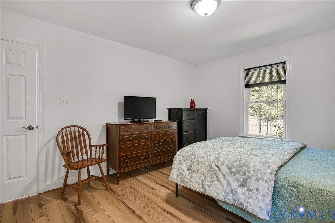 4990 Scandia Road Sandston, VA 23150 - Photo 14 of 25 a bedroom with a bed and a television