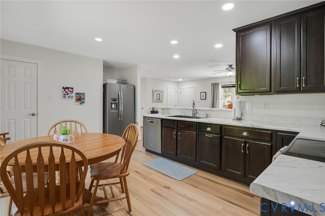 4990 Scandia Road Sandston, VA 23150 - Photo 7 of 25 a kitchen with a table chairs sink and refrigerator