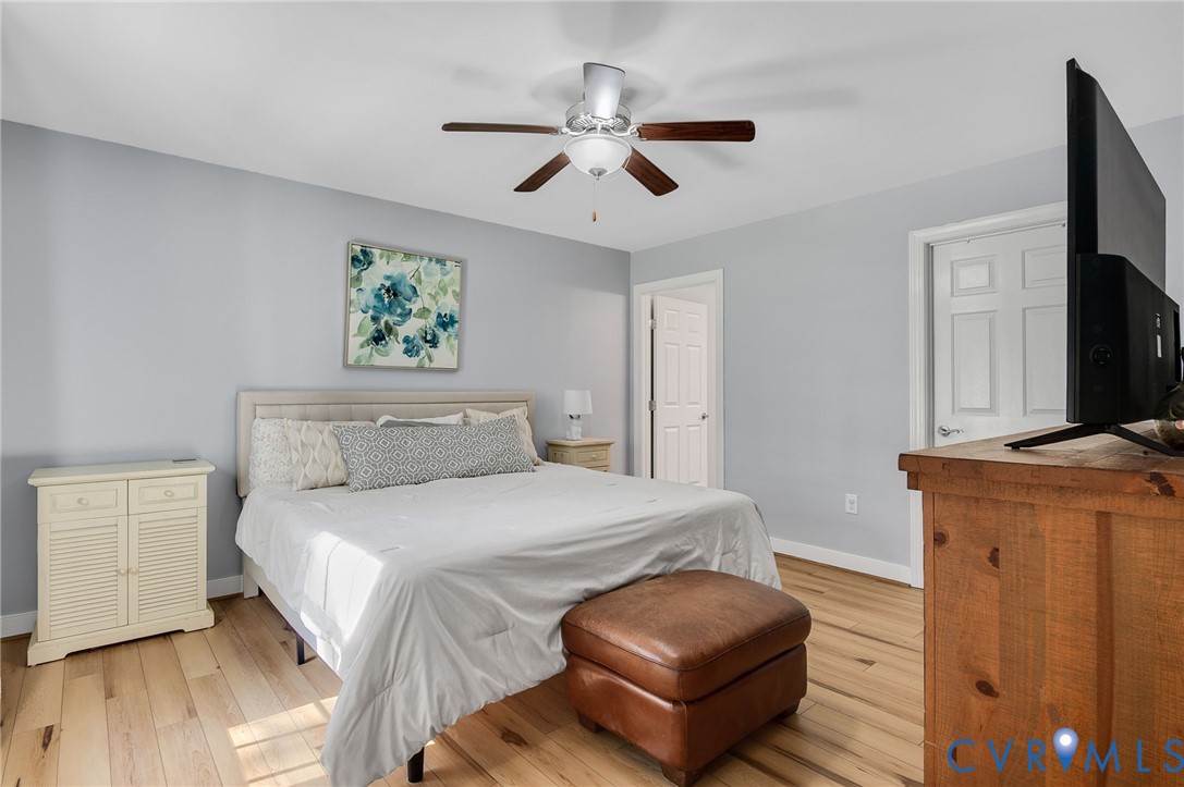 4990 Scandia Road Sandston, VA 23150 - Photo 9 of 25 a bedroom with a bed and a chandelier