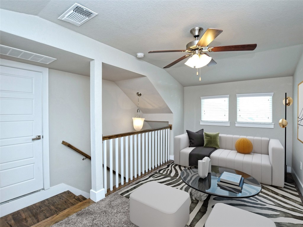 7509 Wildcat Pass Austin, TX 78757 - Photo 27 of 38 Living room featuring lofted ceiling, wood finished floors, a ceiling fan, and a textured ceiling
