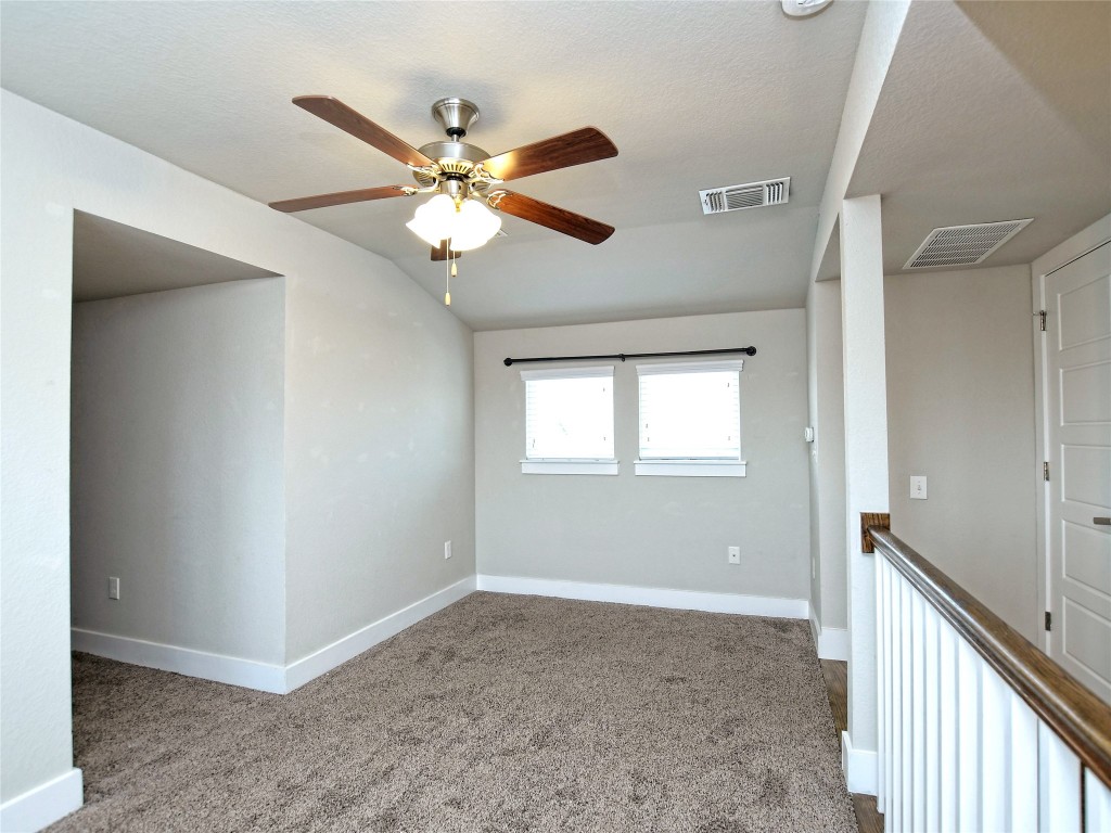 7509 Wildcat Pass Austin, TX 78757 - Photo 29 of 38 Carpeted spare room featuring ceiling fan and vaulted ceiling