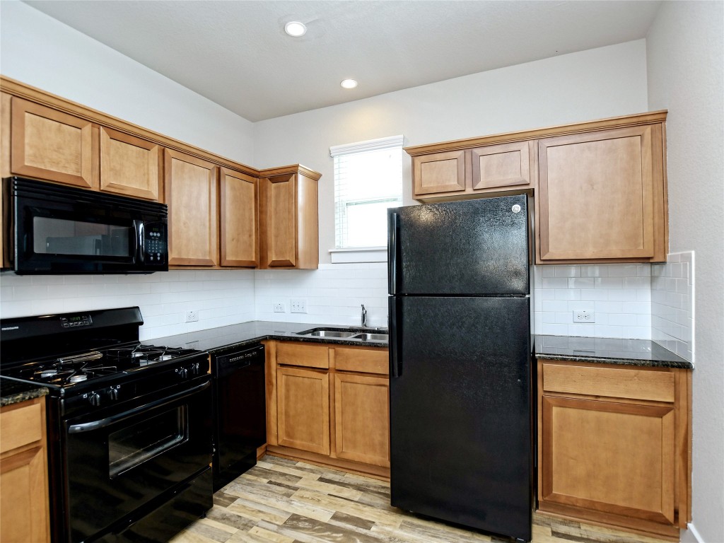 7509 Wildcat Pass Austin, TX 78757 - Photo 38 of 38 Garage ADU Kitchen featuring refrigerator, stove, microwave and dishwaser