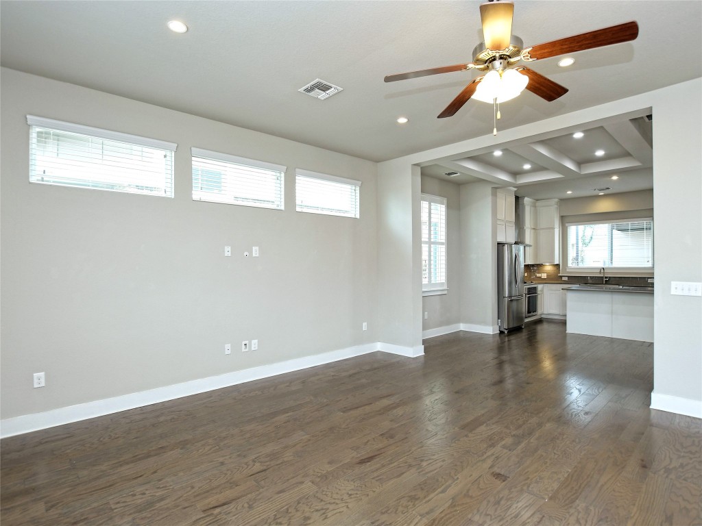 7509 Wildcat Pass Austin, TX 78757 - Photo 9 of 38 Unfurnished living room featuring dark wood-style floors, ceiling fan, and recessed lighting