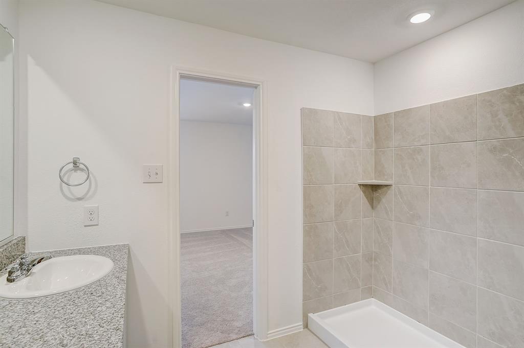2817 Watchpoint Road Little Elm, TX 75068 - Photo 24 of 40 a bathroom with a granite countertop sink a toilet and shower