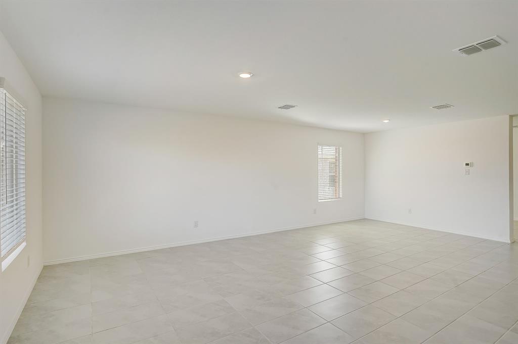 2817 Watchpoint Road Little Elm, TX 75068 - Photo 8 of 40 a view of an empty room with a window