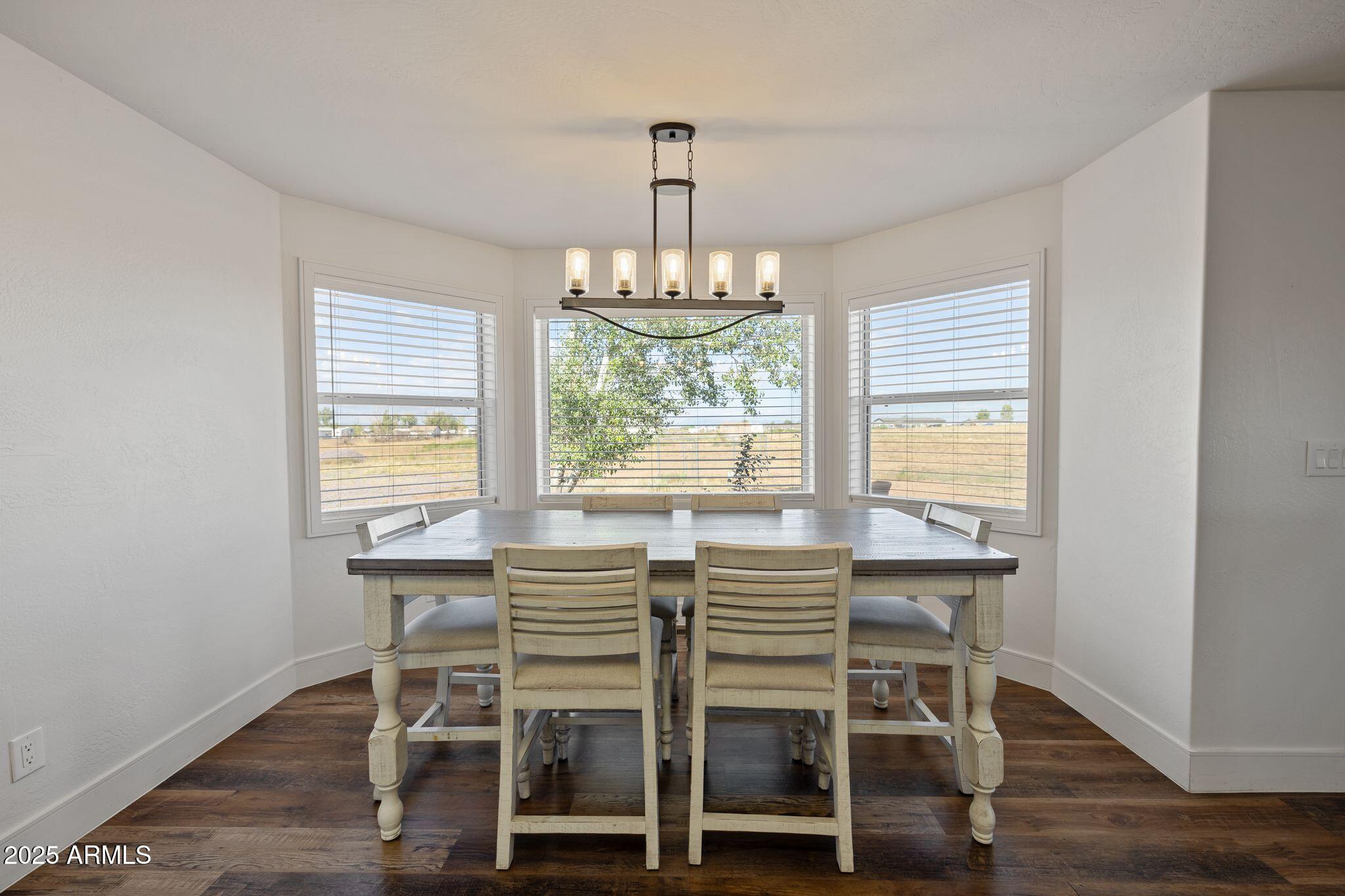 25090 North High Desert Road Paulden, AZ 86334 - Photo 17 of 54 a view of a dining room with furniture window and wooden floor
