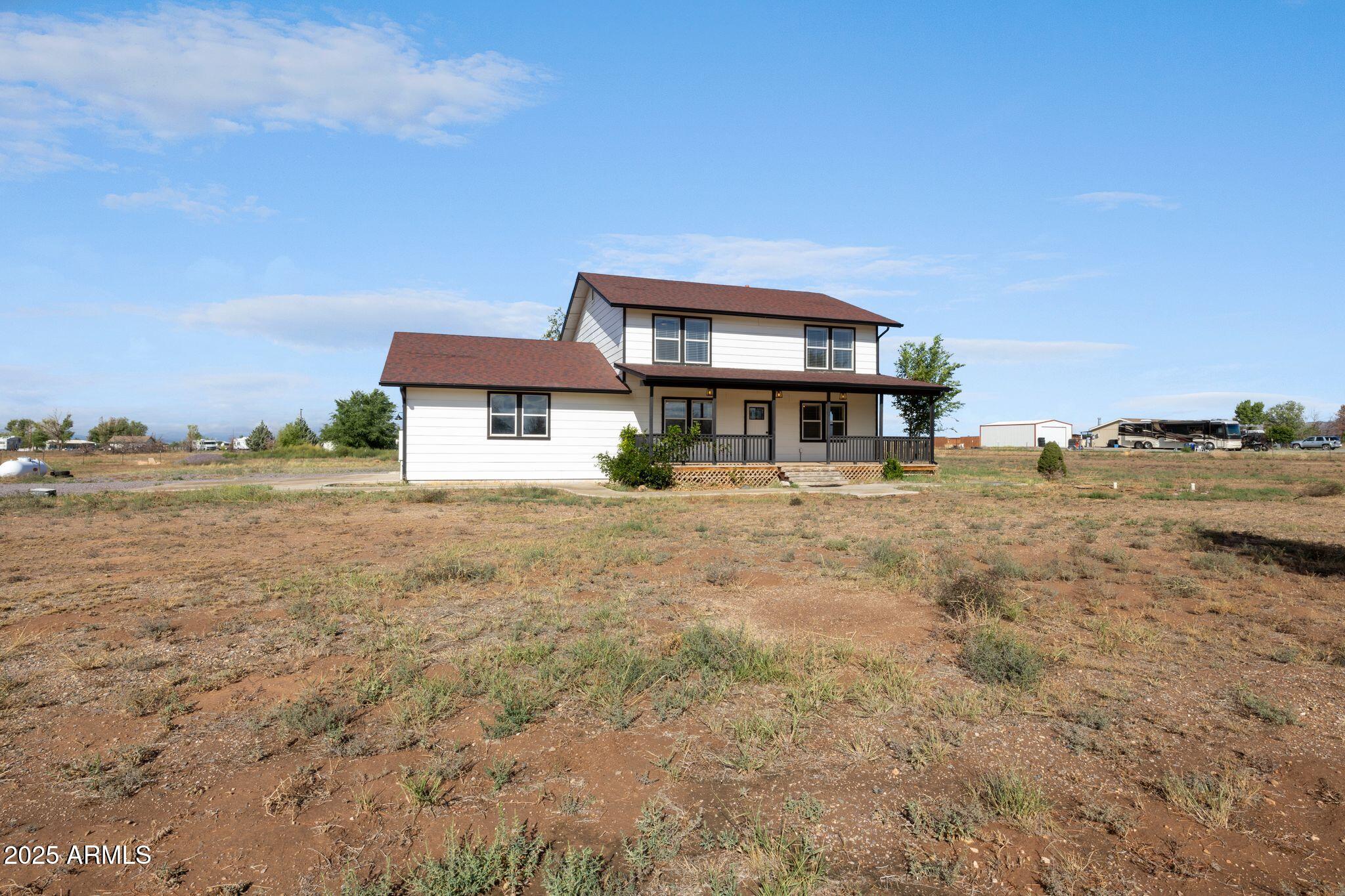 25090 North High Desert Road Paulden, AZ 86334 - Photo 2 of 54 a front view of a building with a yard