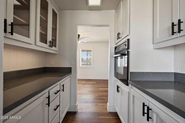 a open kitchen with stainless steel appliances granite countertop a stove dining table chairs and granite counter tops