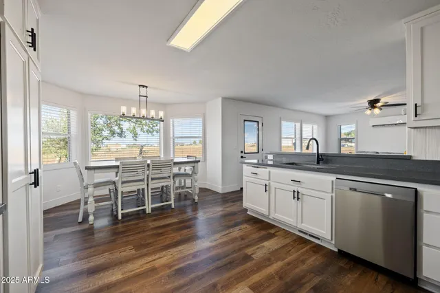 a view of a livingroom with a window and wooden floor