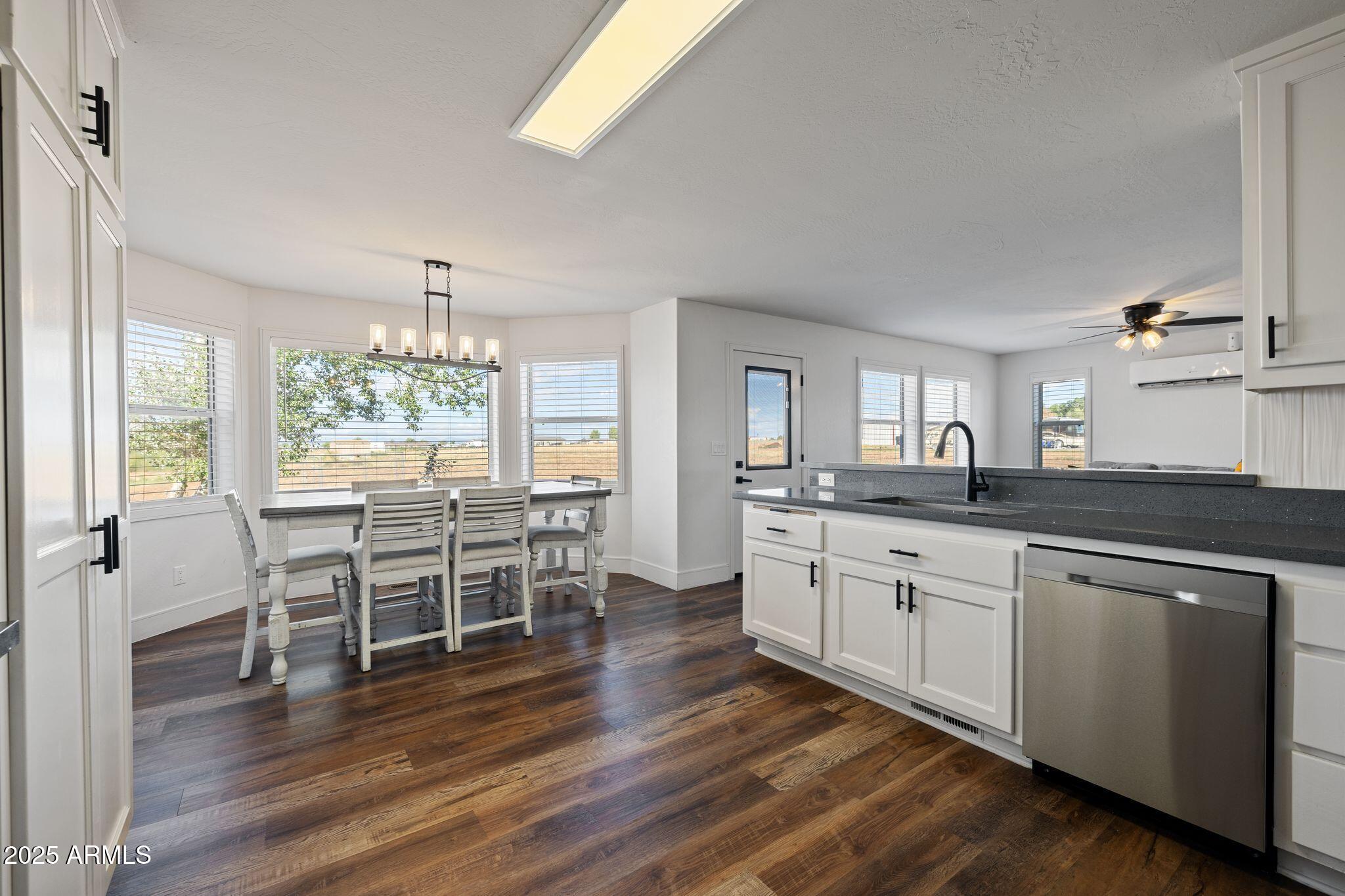 25090 North High Desert Road Paulden, AZ 86334 - Photo 23 of 54 a open kitchen with stainless steel appliances granite countertop a stove dining table chairs and granite counter tops
