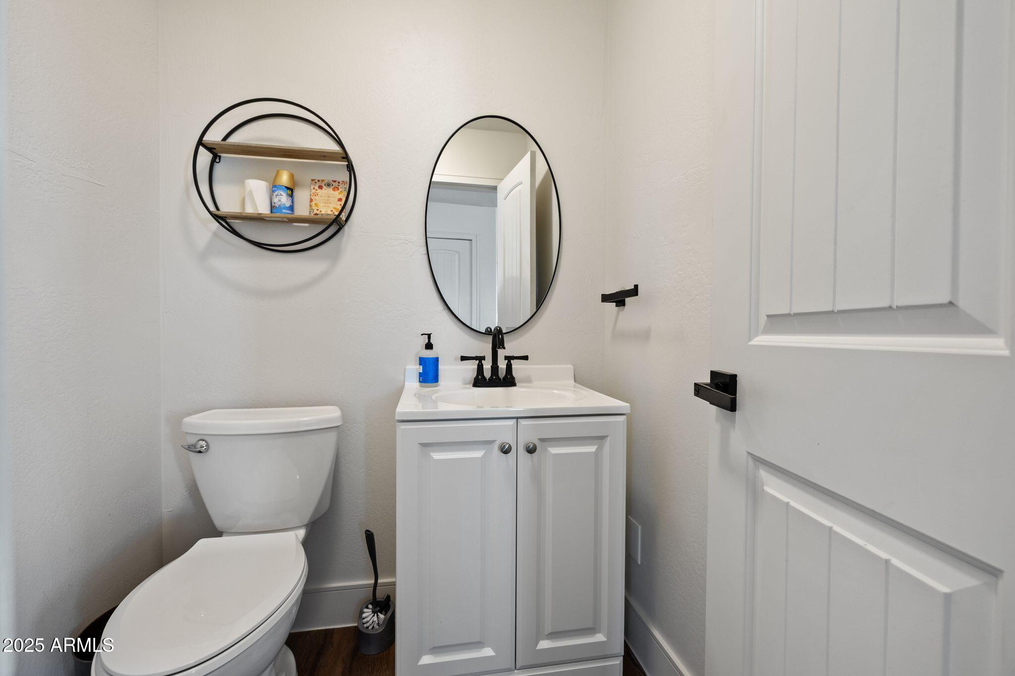 25090 North High Desert Road Paulden, AZ 86334 - Photo 24 of 54 a bathroom with a toilet a sink and a mirror