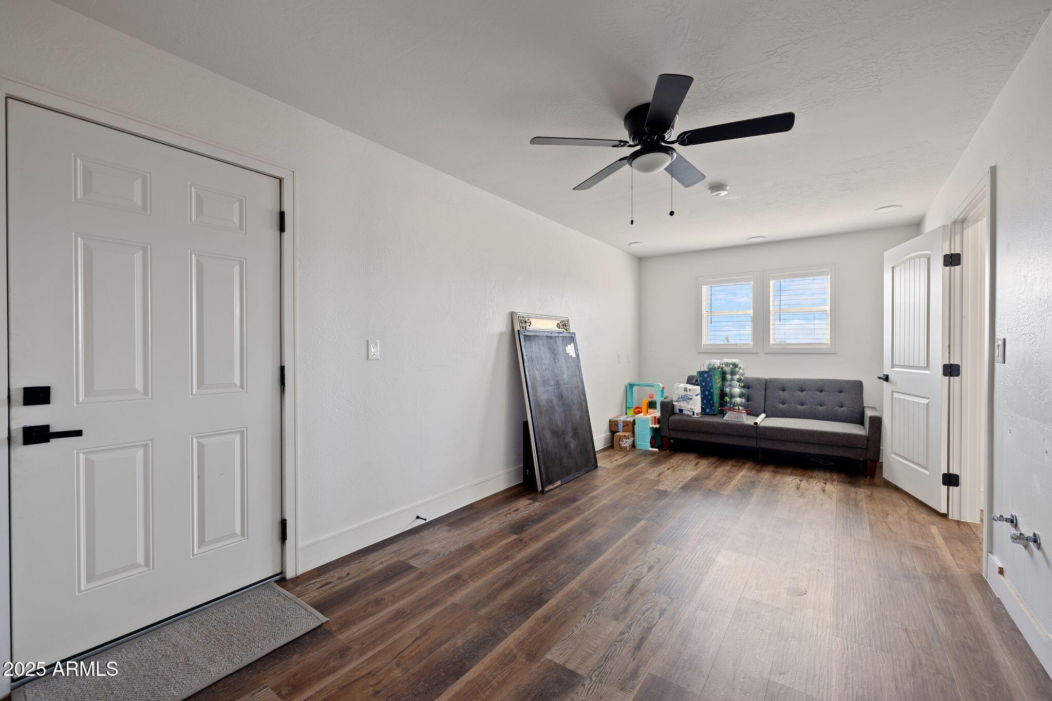 25090 North High Desert Road Paulden, AZ 86334 - Photo 25 of 54 a view of a livingroom with a window and wooden floor