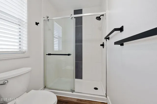 an empty room with a ceiling fan and carpet