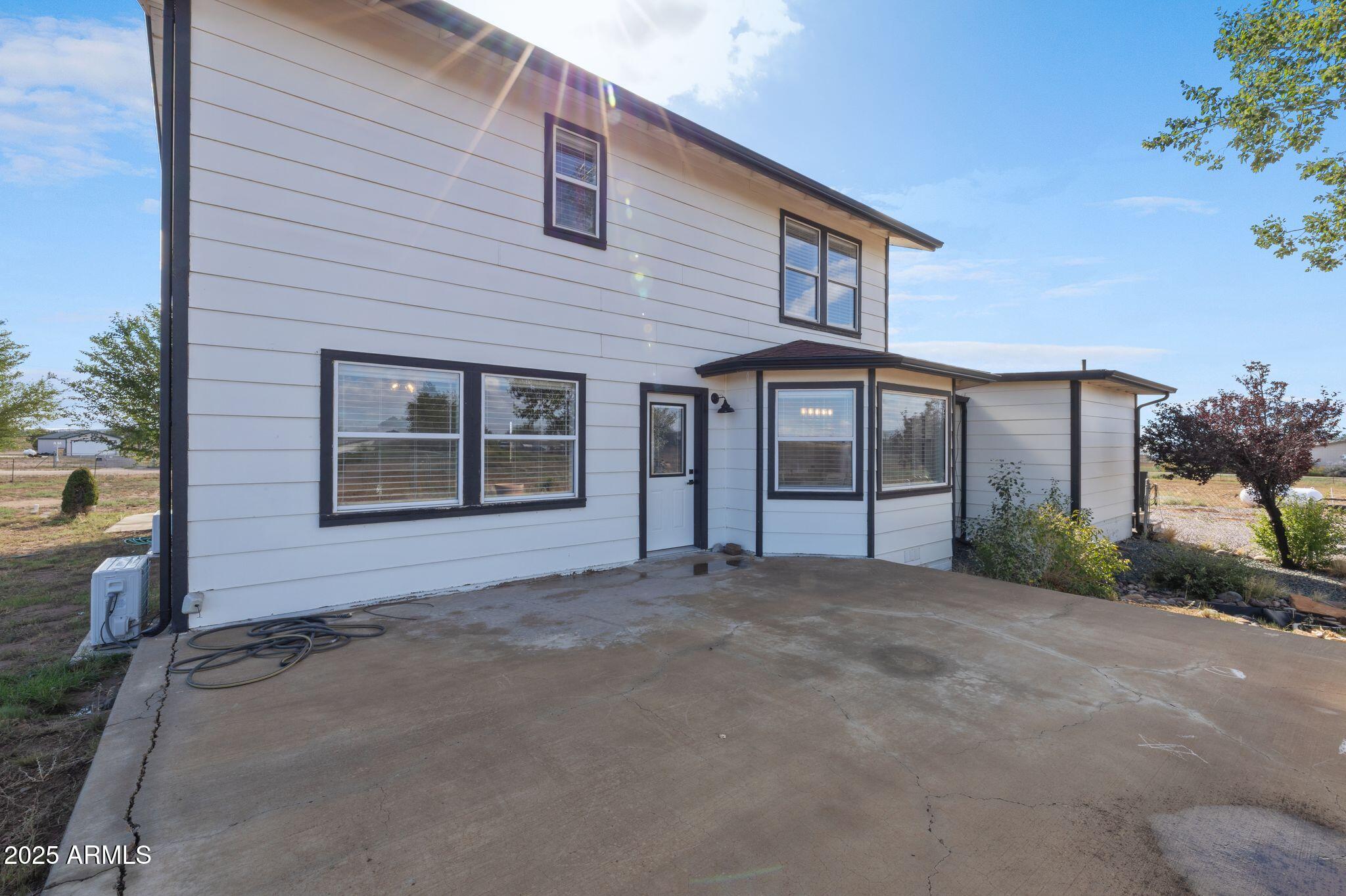 25090 North High Desert Road Paulden, AZ 86334 - Photo 45 of 54 a front view of a house with a garden and garage