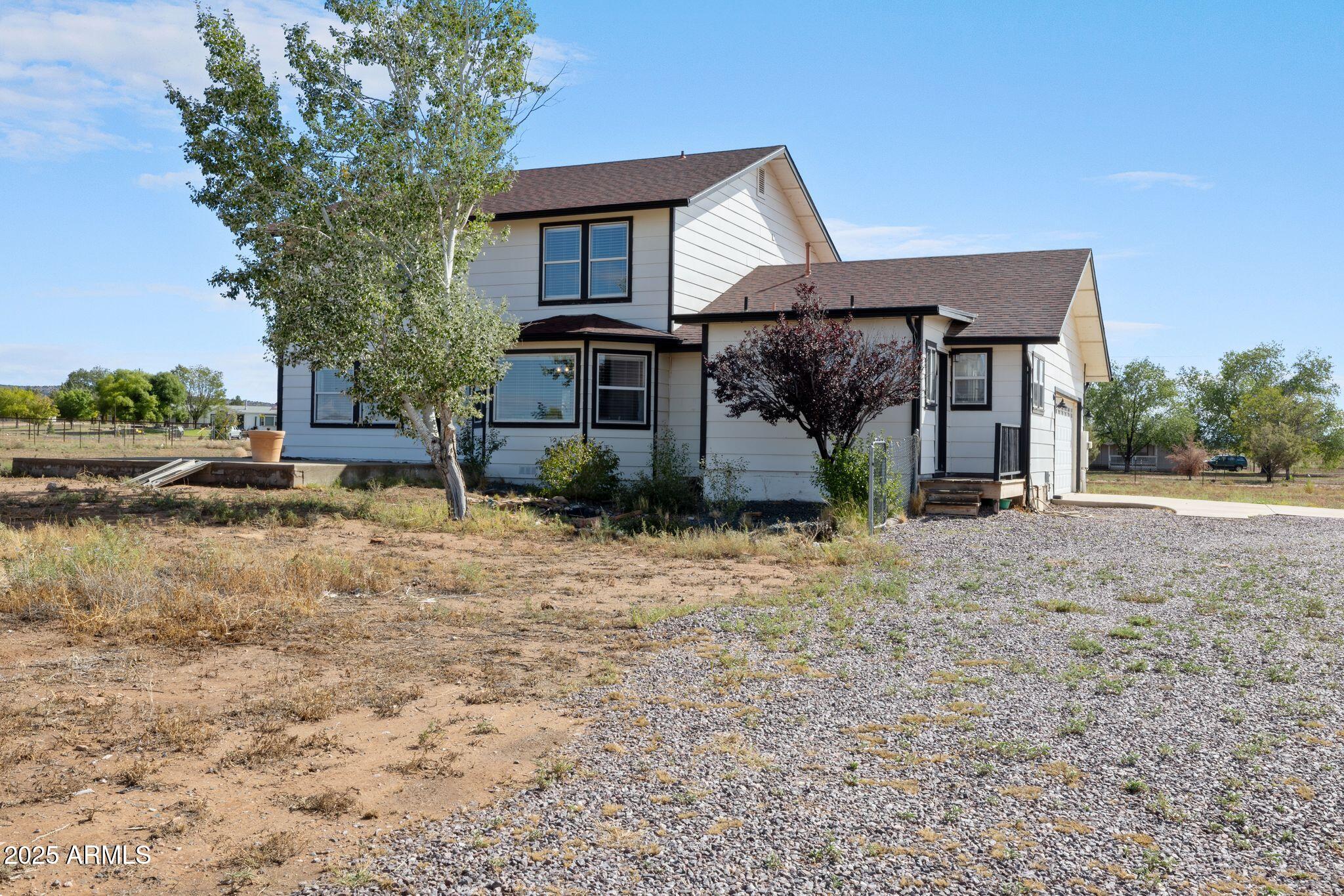25090 North High Desert Road Paulden, AZ 86334 - Photo 50 of 54 a front view of a house with garden