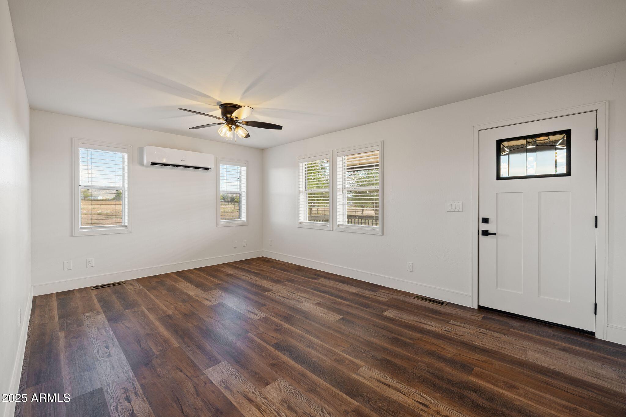 25090 North High Desert Road Paulden, AZ 86334 - Photo 7 of 54 a view of an empty room with wooden floor and a window