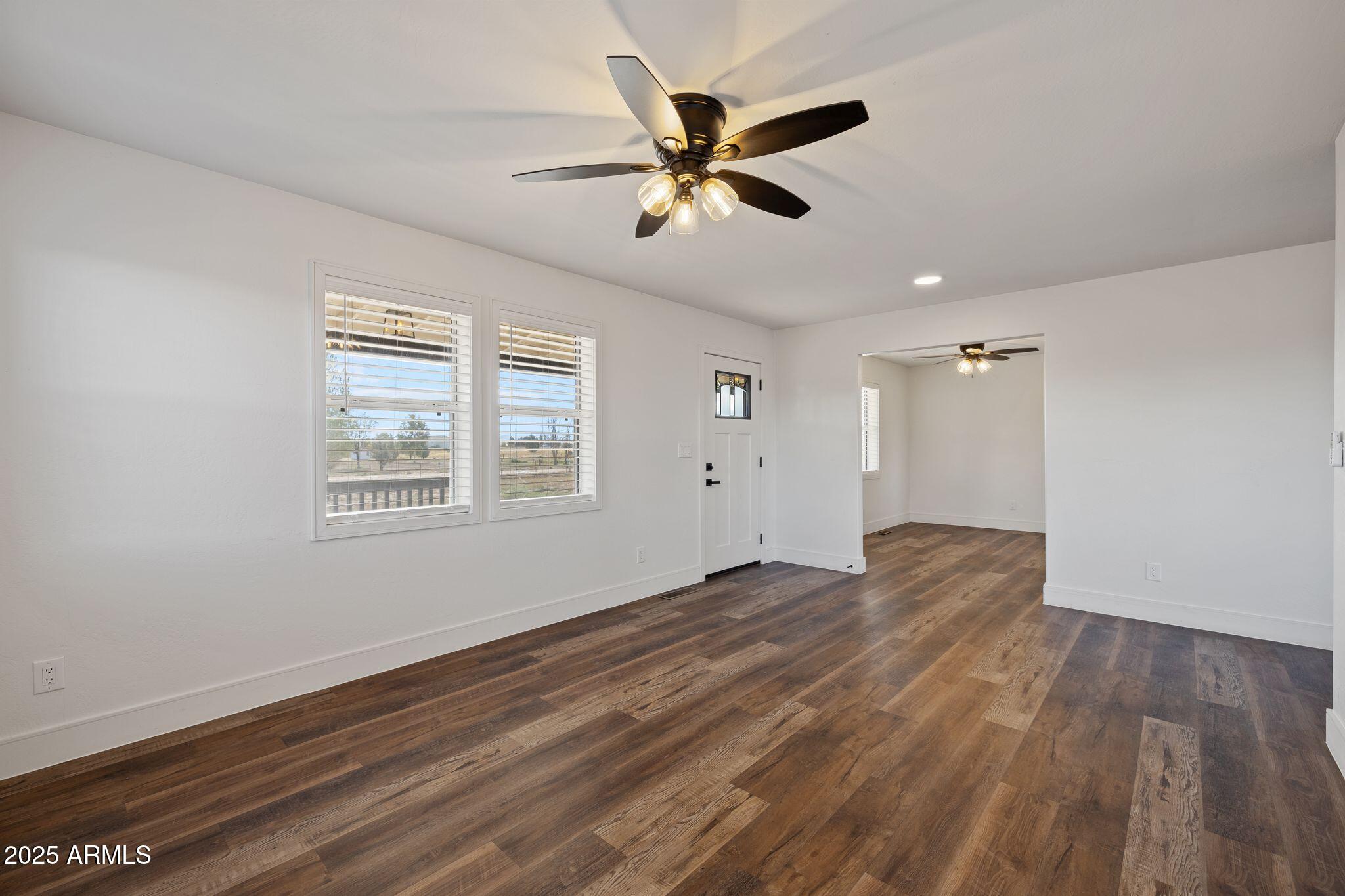 25090 North High Desert Road Paulden, AZ 86334 - Photo 8 of 54 a view of empty room with wooden floor and ceiling fan