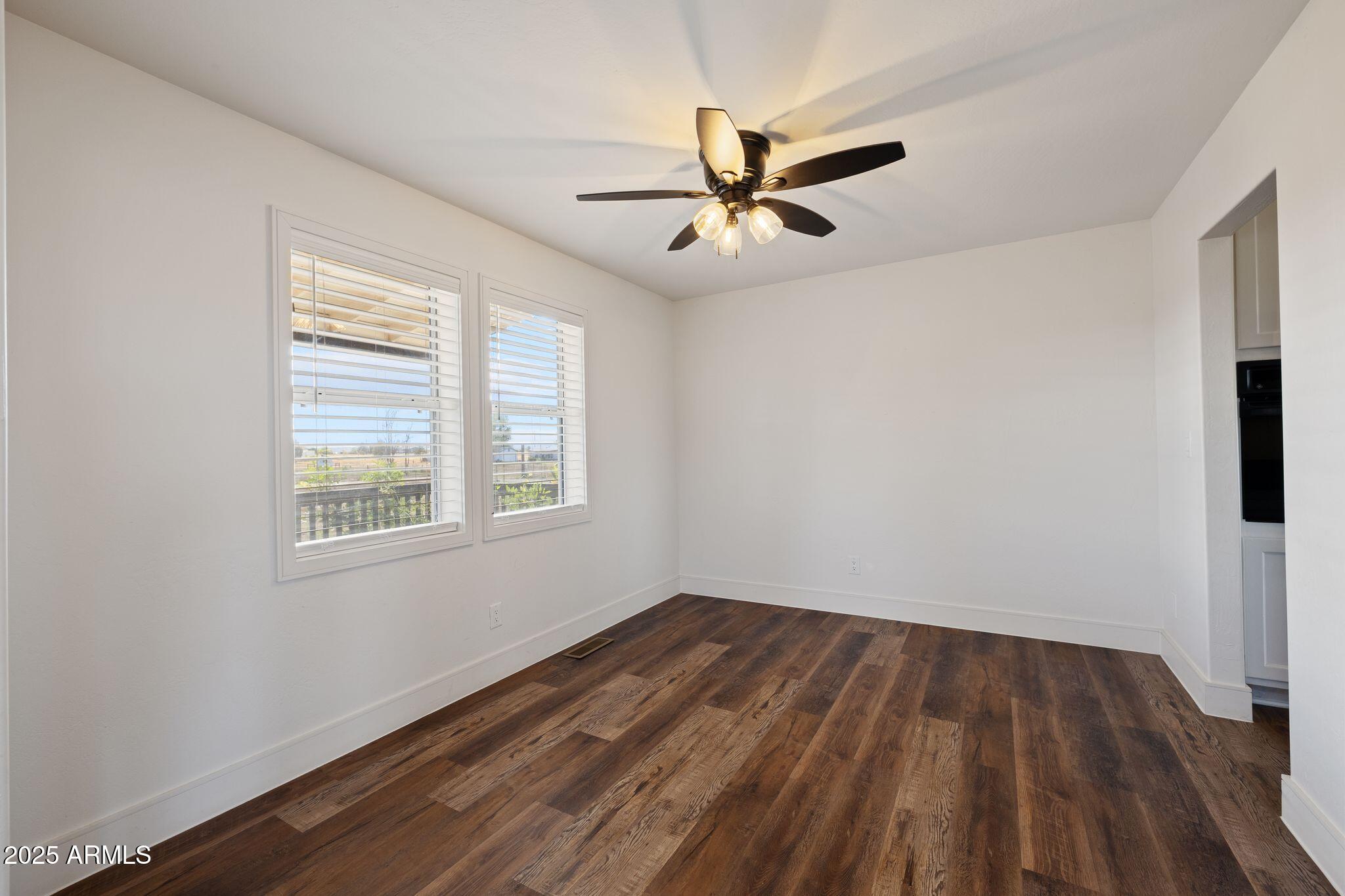 25090 North High Desert Road Paulden, AZ 86334 - Photo 9 of 54 a view of empty room with wooden floor and fan