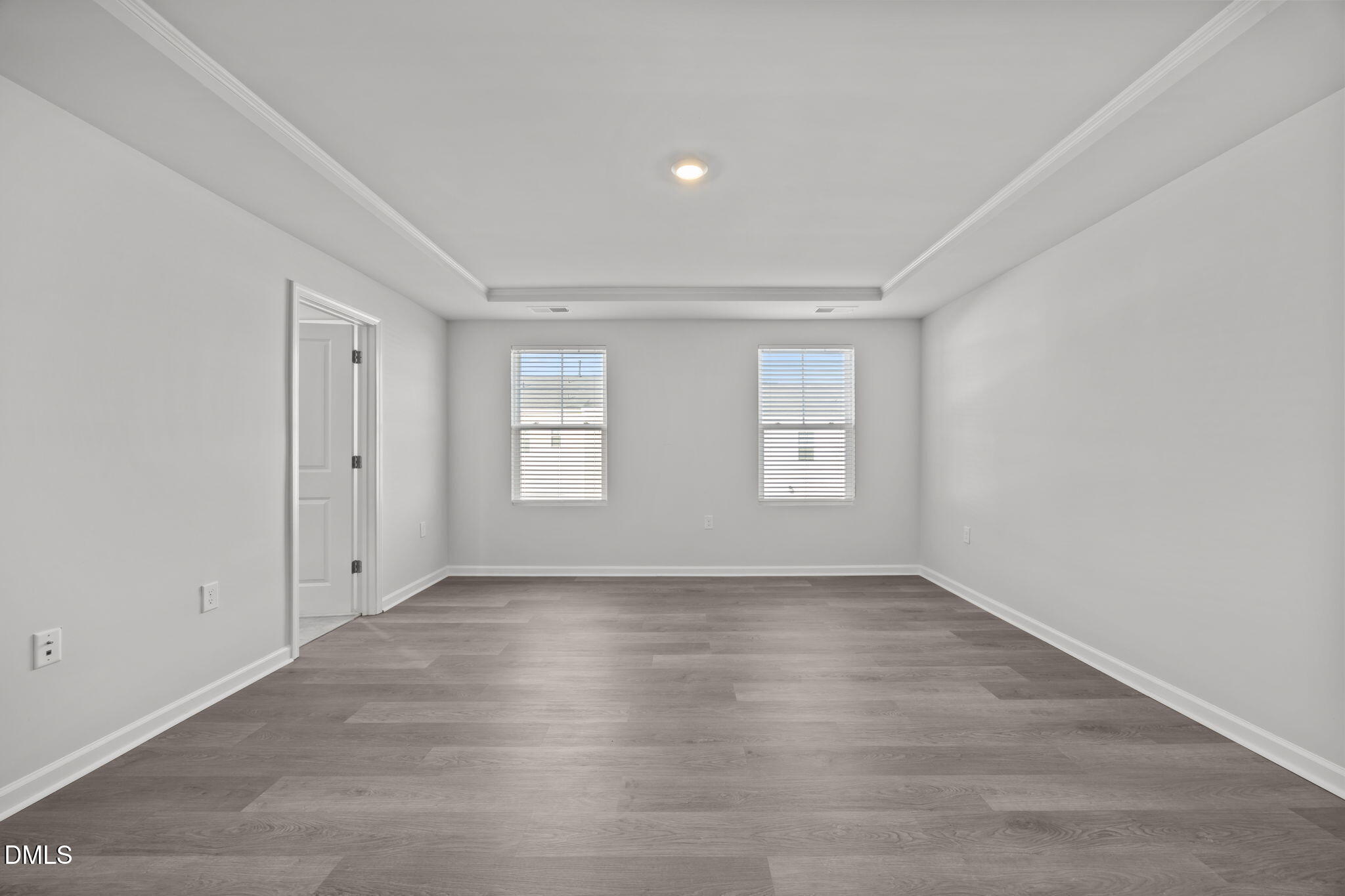 2402 Chert Lane Raleigh, NC 27610 - Photo 17 of 65 a view of an empty room with wooden floor and window