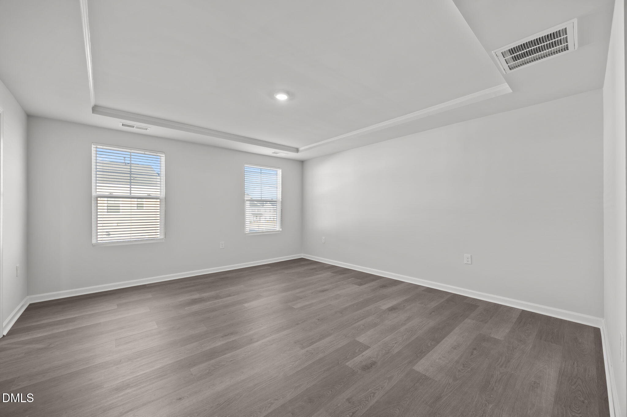 2402 Chert Lane Raleigh, NC 27610 - Photo 18 of 65 an empty room with wooden floor and windows