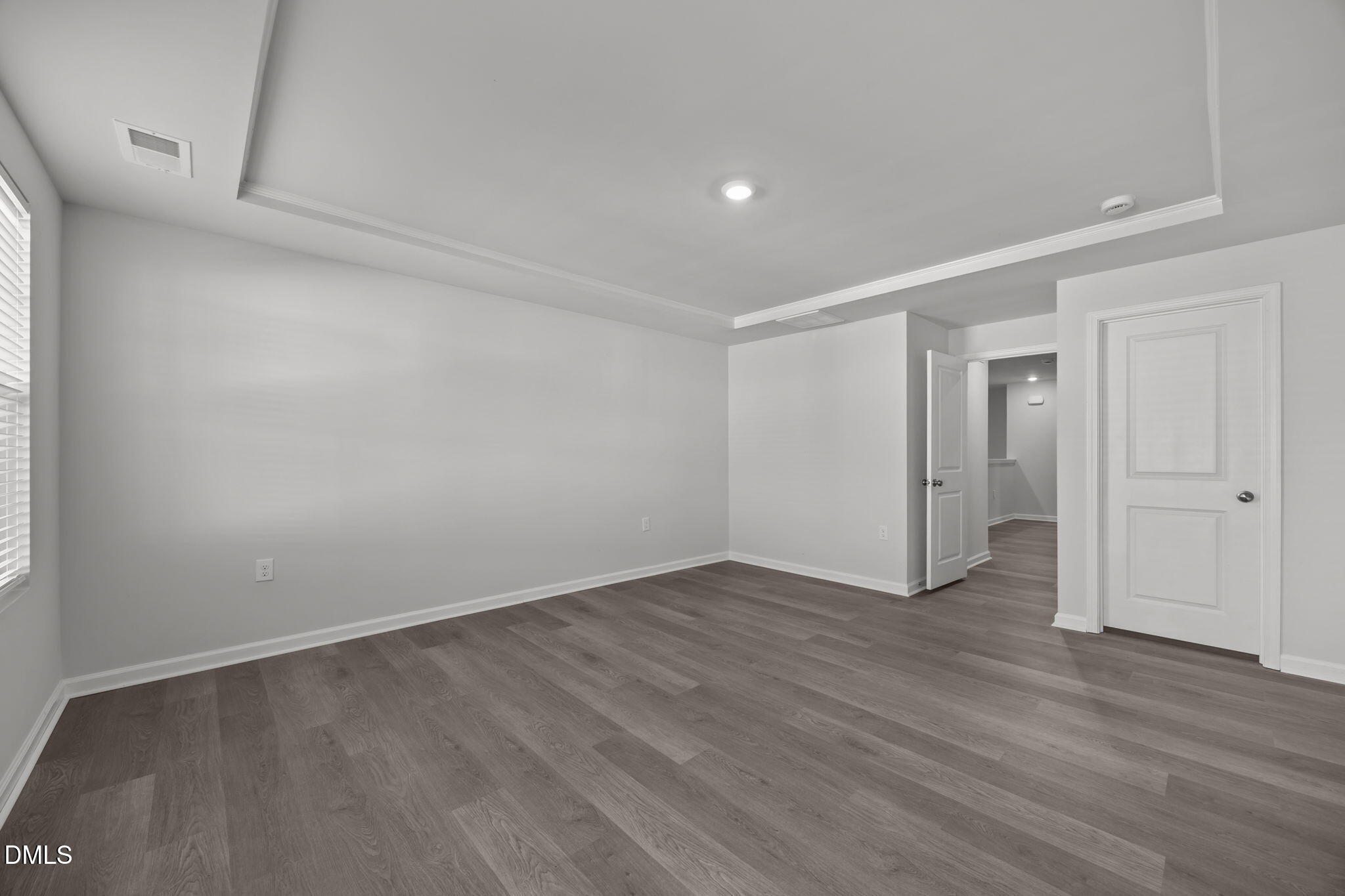 2402 Chert Lane Raleigh, NC 27610 - Photo 19 of 65 a view of an empty room with wooden floor and closet