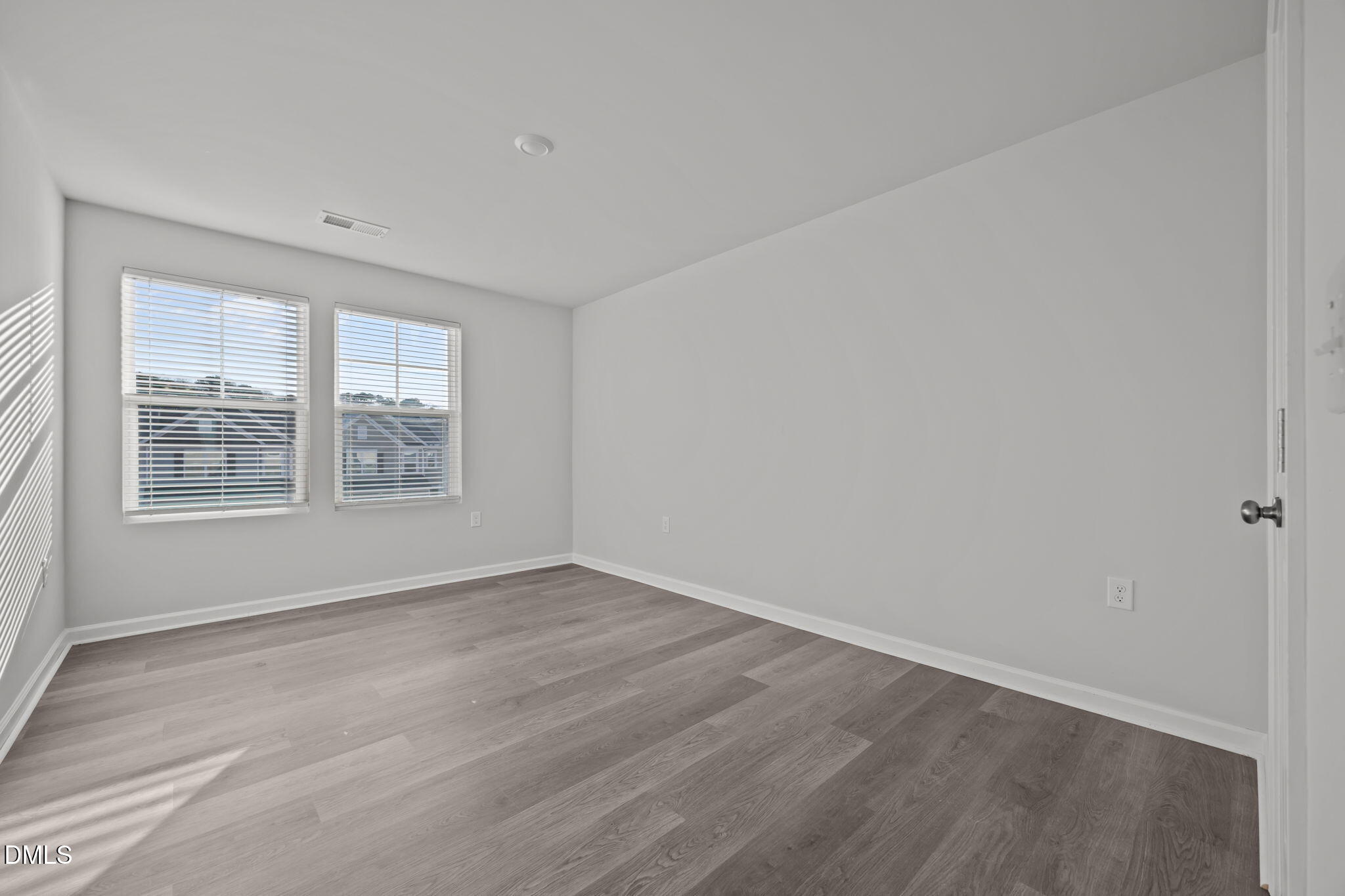2402 Chert Lane Raleigh, NC 27610 - Photo 24 of 65 wooden floor in an empty room with a window