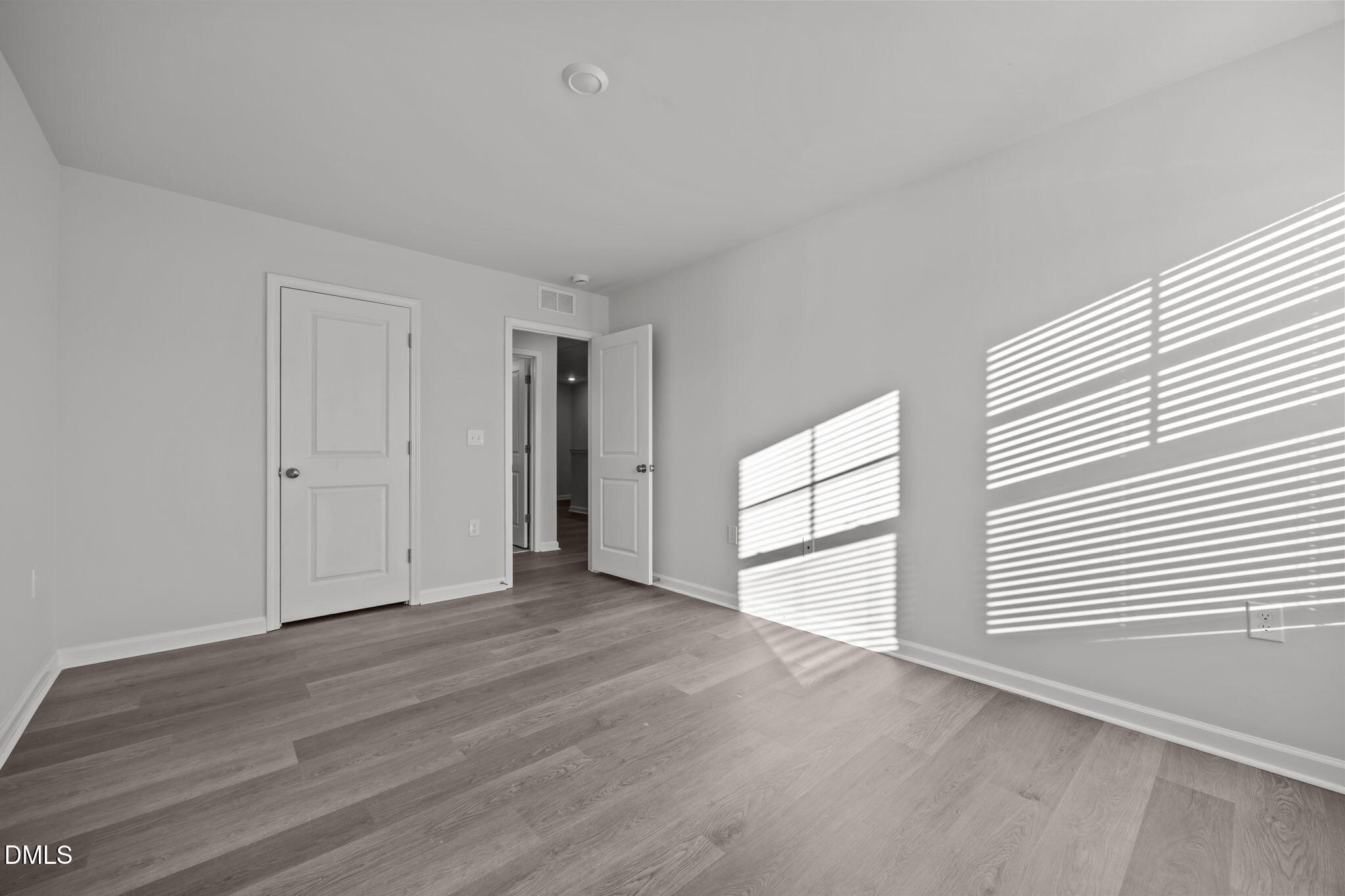 2402 Chert Lane Raleigh, NC 27610 - Photo 25 of 65 a view of empty room with wooden floor and fan