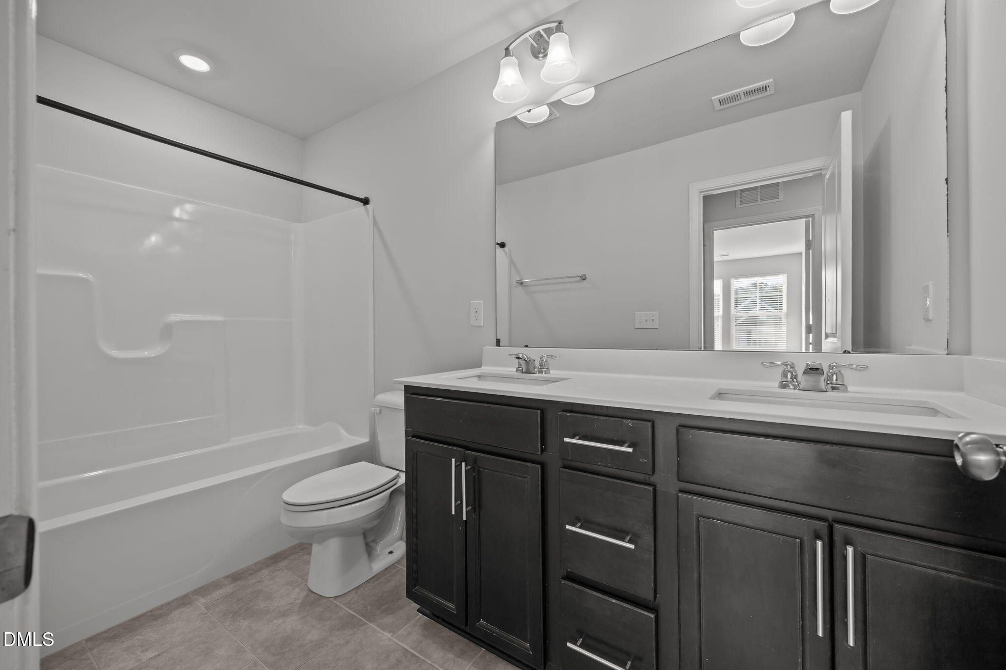 2402 Chert Lane Raleigh, NC 27610 - Photo 26 of 65 a bathroom with a granite countertop sink toilet a large mirror a bathtub and shower