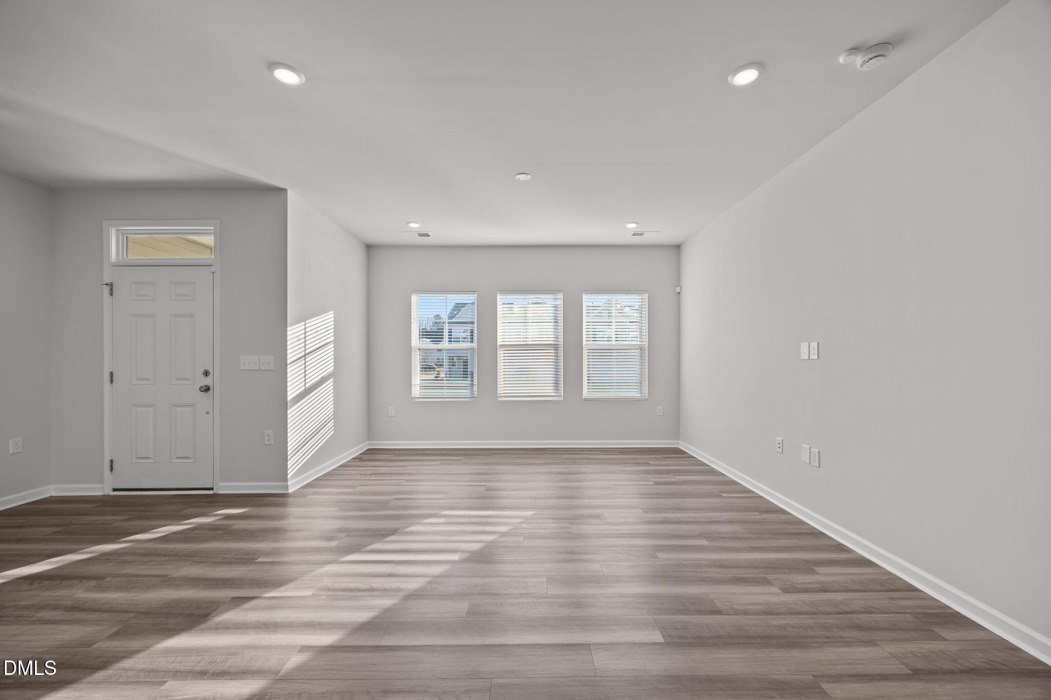 2402 Chert Lane Raleigh, NC 27610 - Photo 10 of 65 a view of an empty room with wooden floor and a window